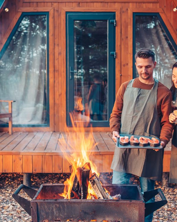 Young couple at autumn warm day grill and relax